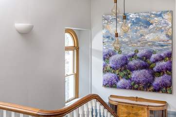 The elegant staircase with beautiful period furniture.