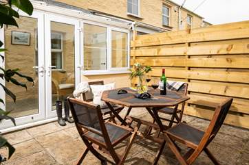 The sunny patio, and the cottage entrance through the conservatory.
