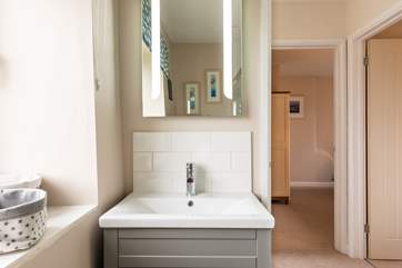 The shower-room has lovely grey units.