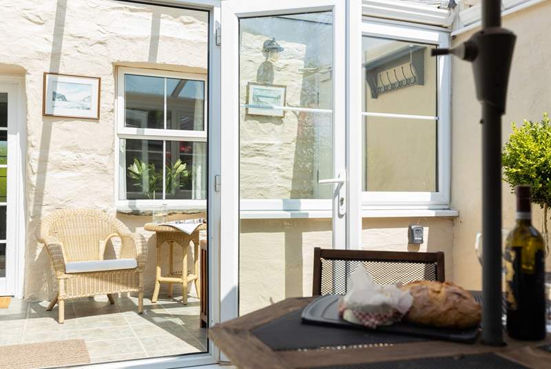 The sunny conservatory is a lovely spot for a morning coffee and of course cake. The solid fire door through to the neighbouring property is always securely locked and bolted on both sides.