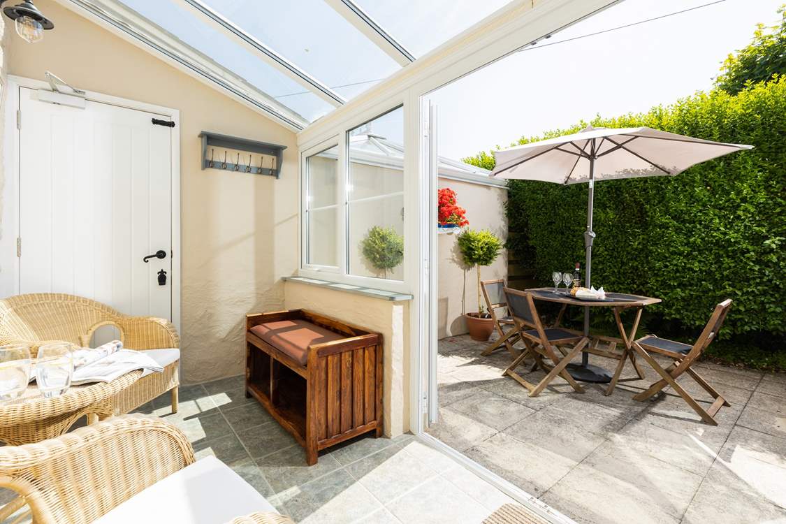 The sunny conservatory leads out onto the patio.