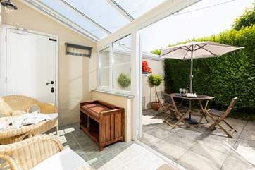 The sunny conservatory leads out onto the patio.