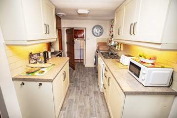 From the kitchen you access the downstairs bedroom, bathroom and utility-area.