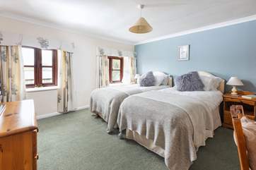 The twin bedroom on the first floor looks out across the back garden and surrounding countryside.