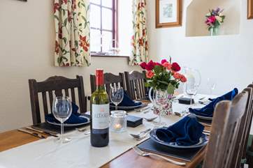 The dining-table sits to the side of the fully equipped kitchen.