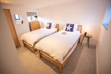 The dual-aspect twin bedroom offers the perfect room to unwind after a day at the beach. Although not 'zip and link' beds the extra deep mattresses allow for the beds to be pushed together if required.