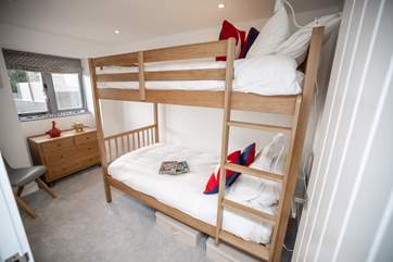 The bunk bedroom has three-foot beds with individual reading lights and views over the garden. Please note the top bunk has limited headroom.