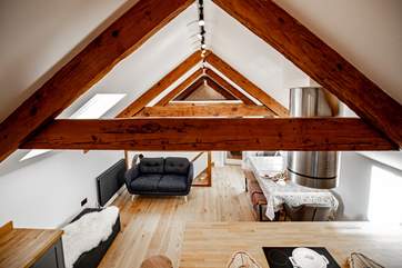 The beams and high ceilings add to the feeling of space and allow light to stream through the skylights and flood the top floor.