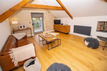 The sitting-room has a wonderful contemporary design; open the door and let in a welcoming breeze.