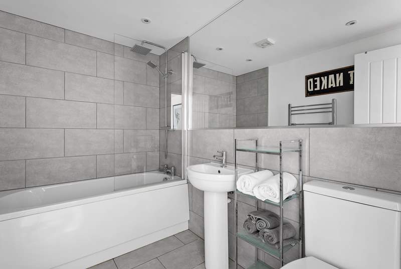 The generous family bathroom offers both under-floor heating and a handy heated towel rail.