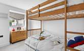 The bunk bedroom has three-foot beds with individual reading lights and views over the garden. Please note the top bunk has limited headroom. - Thumbnail Image