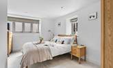 The main bedroom is both spacious and tranquil with neutral tones offering a calming place to rest up and recharge. - Thumbnail Image