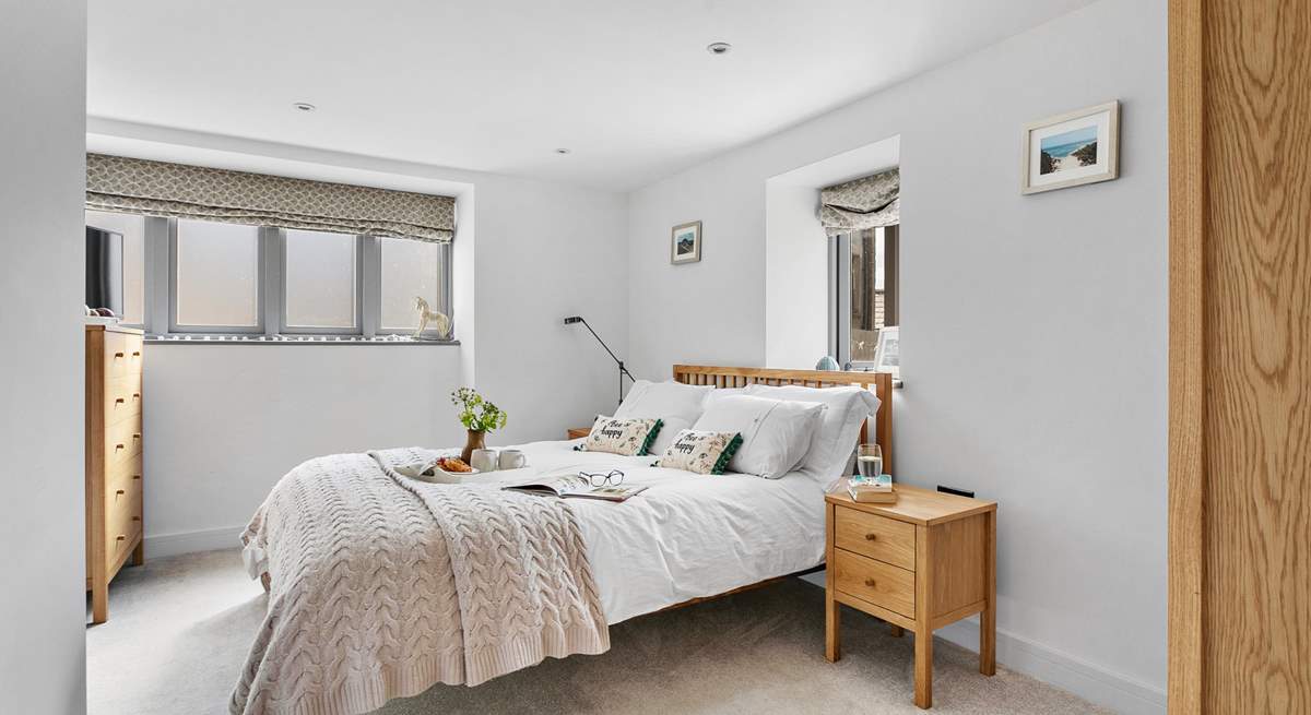 The main bedroom is both spacious and tranquil with neutral tones offering a calming place to rest up and recharge.