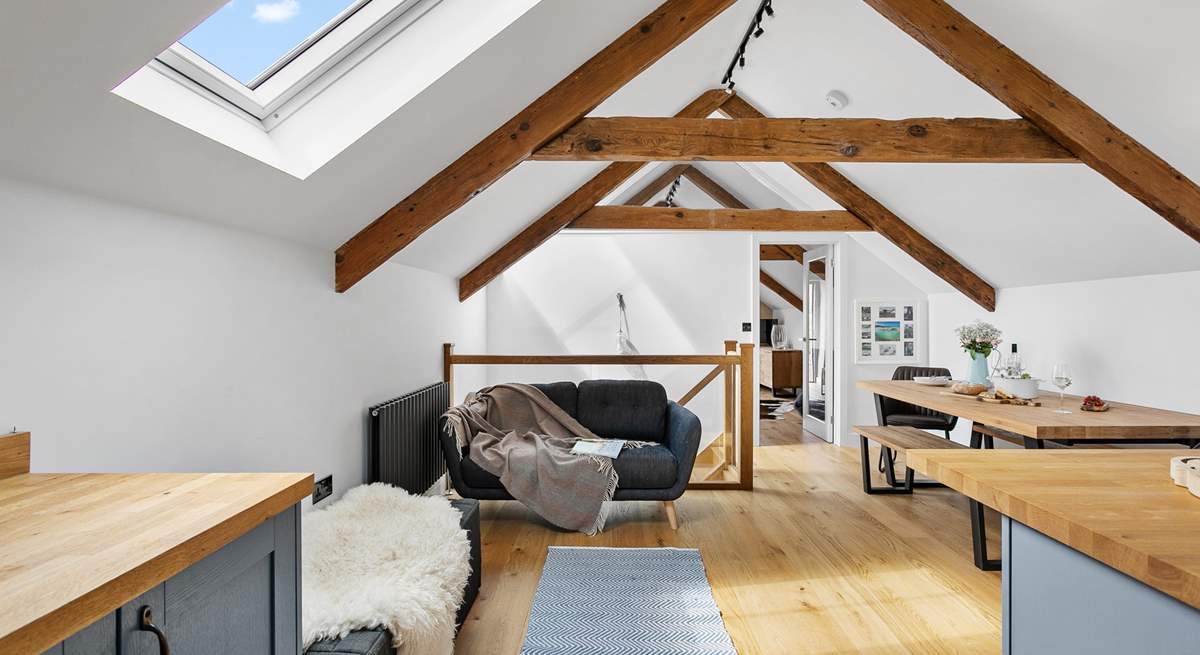 The beams and high ceilings add to the feeling of space and allow light to stream through the skylights and flood the top floor.