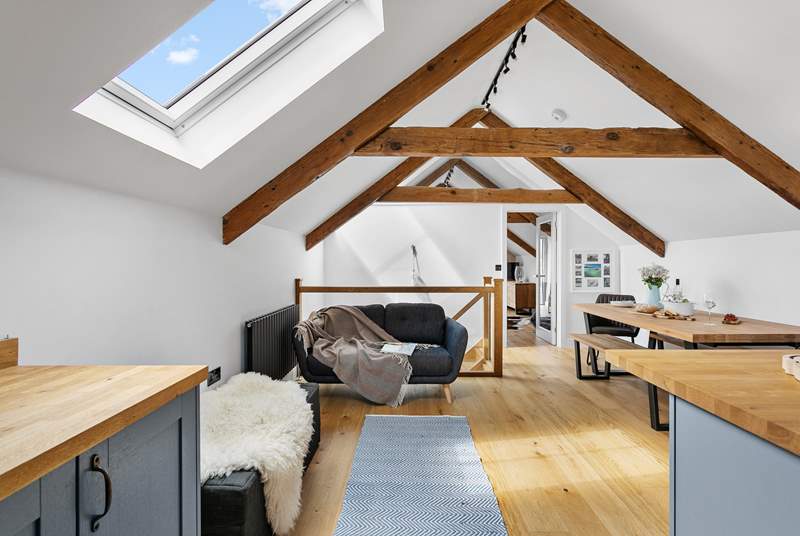 The beams and high ceilings add to the feeling of space and allow light to stream through the skylights and flood the top floor.