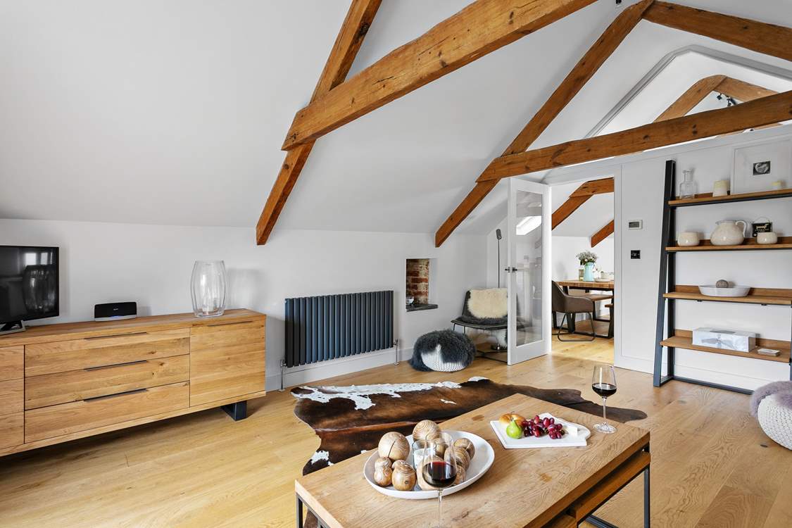 The sitting-room has a wonderful contemporary design; open the door and let in a welcoming breeze.