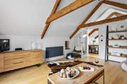 The sitting-room has a wonderful contemporary design; open the door and let in a welcoming breeze.