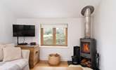 The lovely wood-burner complements the living area. - Thumbnail Image