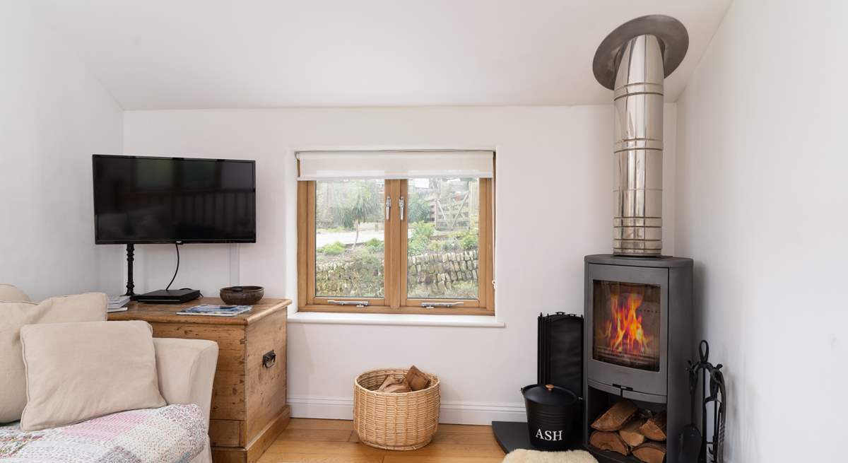 The lovely wood-burner complements the living area.