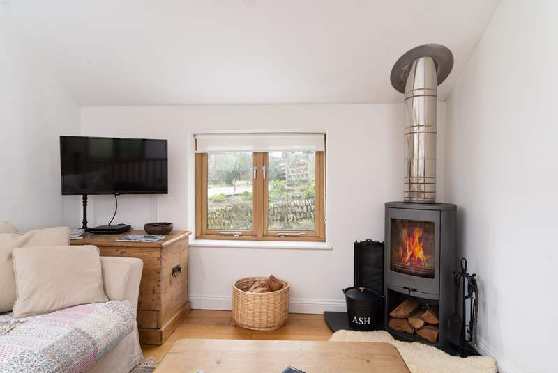 The lovely wood-burner complements the living area.