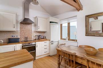 The open plan living room with kitchen and dining area.