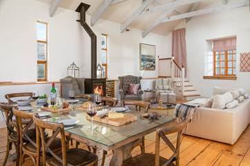 The stunning open plan living area. Steps lead up to a little landing and behind the curtain is an internal door, which is shared with the neighbouring barn. However this door is locked at all times.