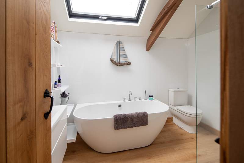 The bathroom is exceptionally spacious, offering a fabulous light and airy feel, and this beautiful bath.