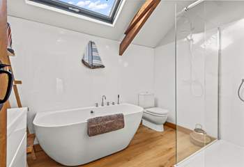 The bathroom is exceptionally spacious, offering a fabulous light and airy feel, and this beautiful bath.