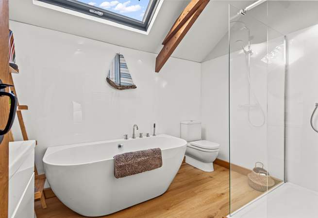 The bathroom is exceptionally spacious, offering a fabulous light and airy feel, and this beautiful bath.
