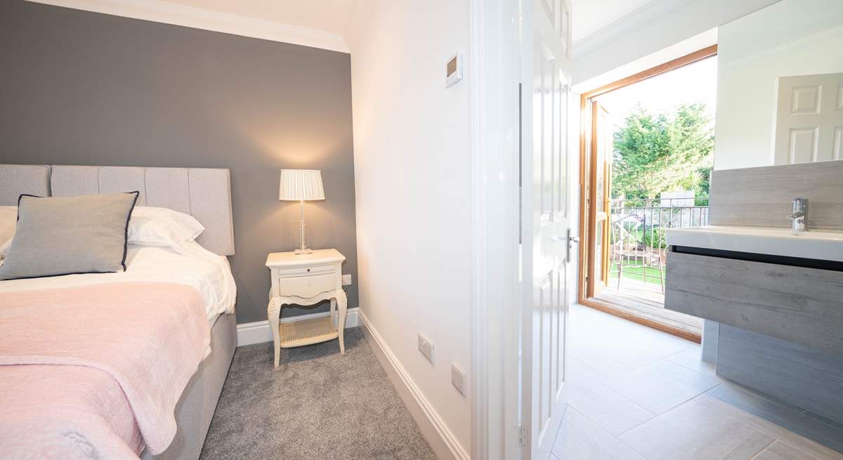 The sumptuous main bedroom on the second floor with en suite bathroom leading out to a balcony.