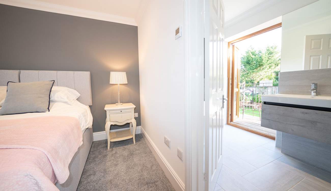 The sumptuous main bedroom on the second floor with en suite bathroom leading out to a balcony.