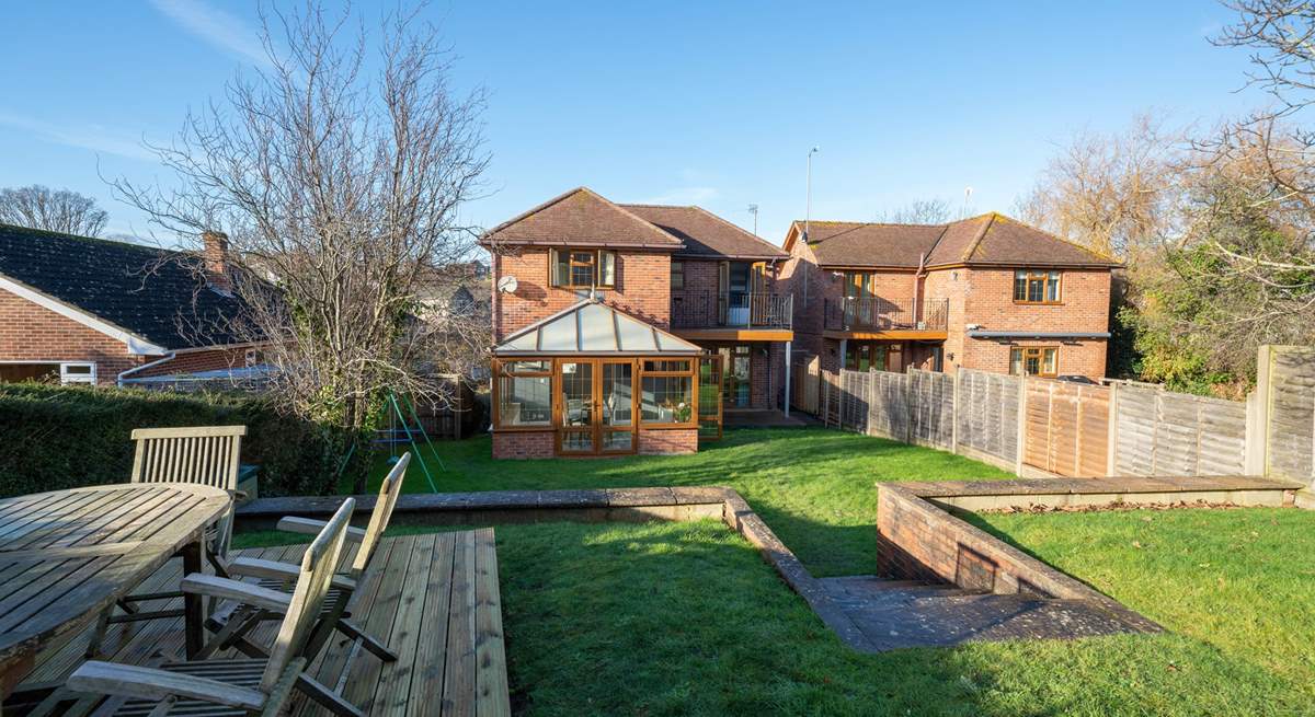 Saye House provides a large garden with a decked-area for outdoor dining. Please note the conservatory now has white trims.