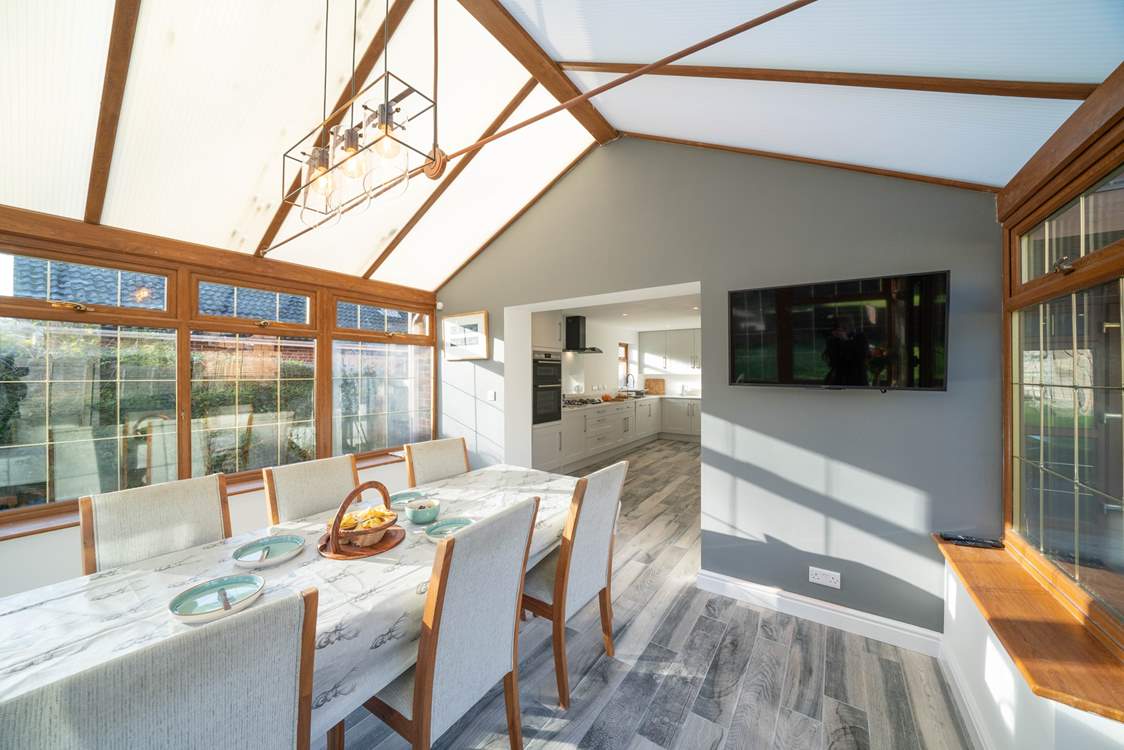 The spacious kitchen/diner, overlooking the garden, is a real sun-trap. Please note this room now has white trims around the windows.