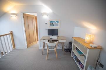 The PlayStation is outside Bedroom 3 at one end of the mezzanine area, with Bedroom 2 at the other end.