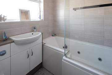 Family bathroom with bath and shower.