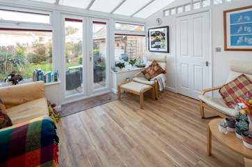 The conservatory is a great place to enjoy the great outdoors from a comfy seating area. ***New furniture will be in this room for 2021***