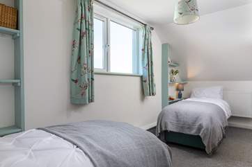 This bedroom has useful flexibility of beds.