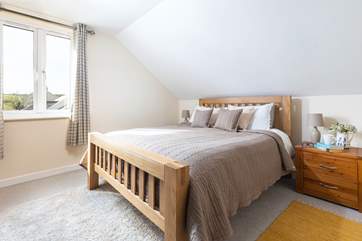 The main bedroom decorated in calming tones.