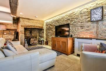 This beautiful room benefits from the orginal stone being exposed, perfectly showcased by the lighting that has been installed. The wood-burner has now been installed in the fireplace.