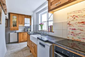 This wonderful kitchen sits at the back of the house, with a door out to the courtyard area and outhouse that houses the washing machine and tumble-drier.