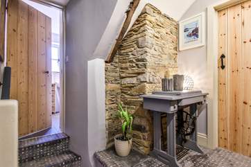 The top of the landing is separated by steps up and down into the bathroom and bedrooms. The stairs have downlighters installed for the perfect night light.