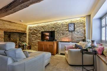 The living area benefits from a wonderfully large Smart television for all the family to enjoy film night.