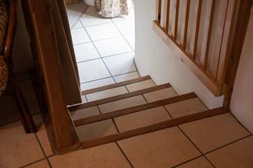 Steps lead down from the dining-area into the sitting-room.