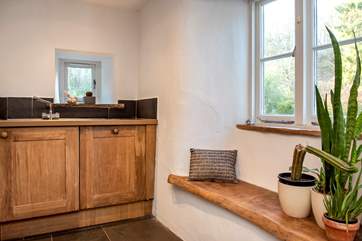 A lovely window seat with the oak sill perfectly complementing the slate floors.
