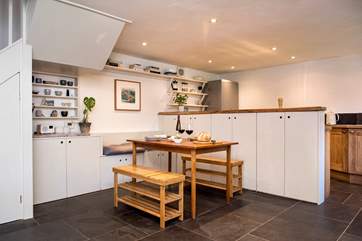 The counter forms a natural divide between the kitchen and dining areas.