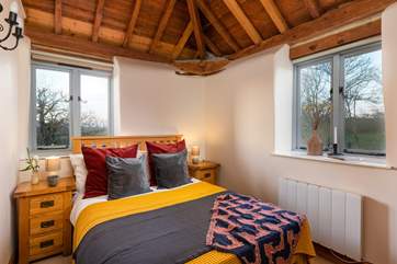 Bedroom two, a wonderful space to relax and recharge. There are views across the fields and a wonderful vaulted ceiling.