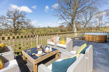 Enjoy your enclosed patio with private hot tub and views across the fields and down to the two lakes.
