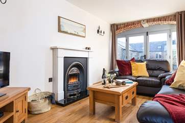 The open plan living-room is flooded with light, a great space for family gatherings.