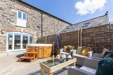Step through the patio doors and you will find the gorgeous hot tub in your private courtyard.