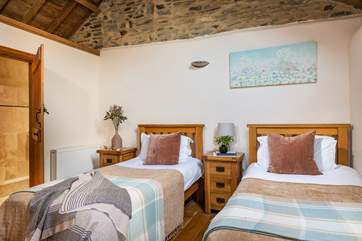 The twin room is furnished beautifully with oak furniture and crisp white bedding. The bedroom also benefits from an en suite shower-room, vaulted ceiling and exposed beams and brick work.